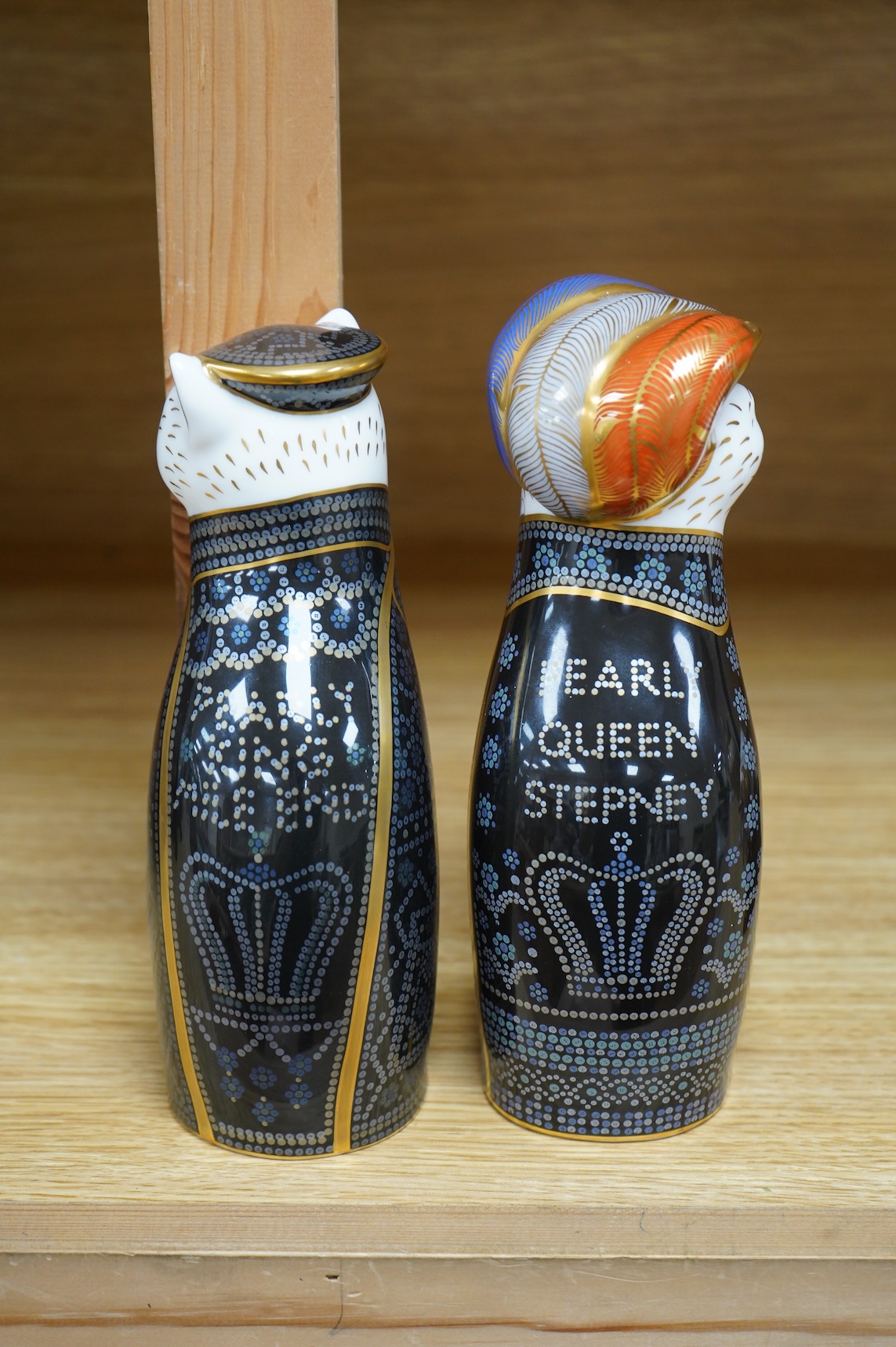 Two Royal Crown Derby cats compromising Pearly Queen and King, one with stopper, largest 20cm high